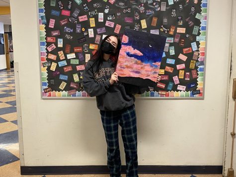 Senior Mariana Esposito is shown displaying her piece of artwork.