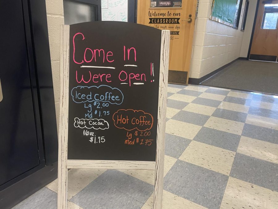 This sign can be seen in the end of the middle school hall welcoming patrons into the coffee shop. 