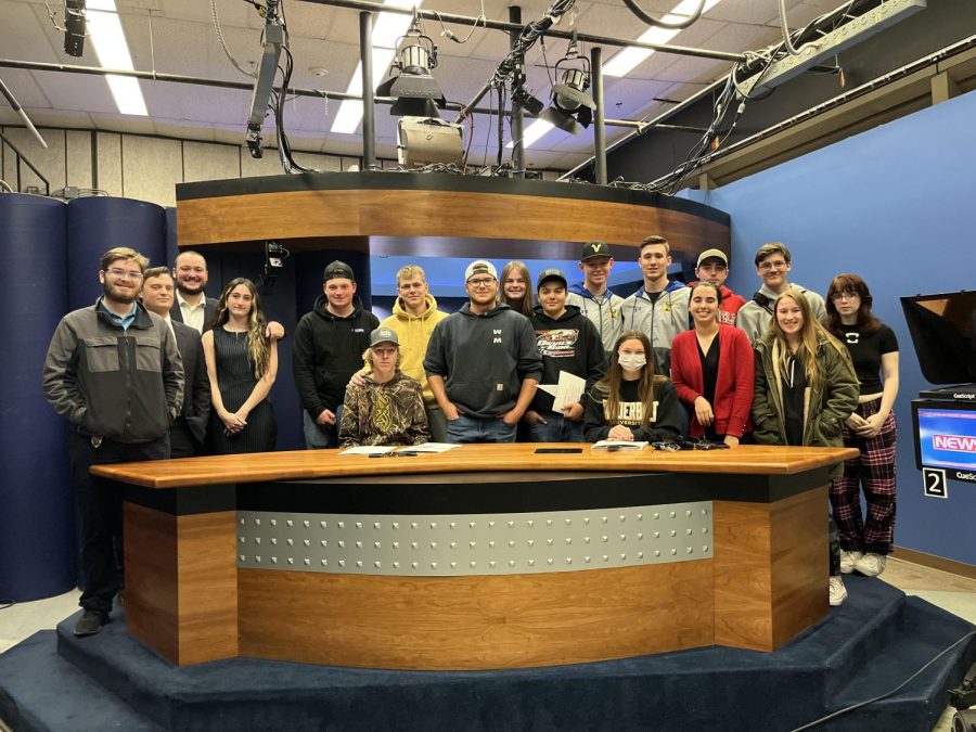 BNN students pose at the News 7 desk alongside students from the NVU journalism program.