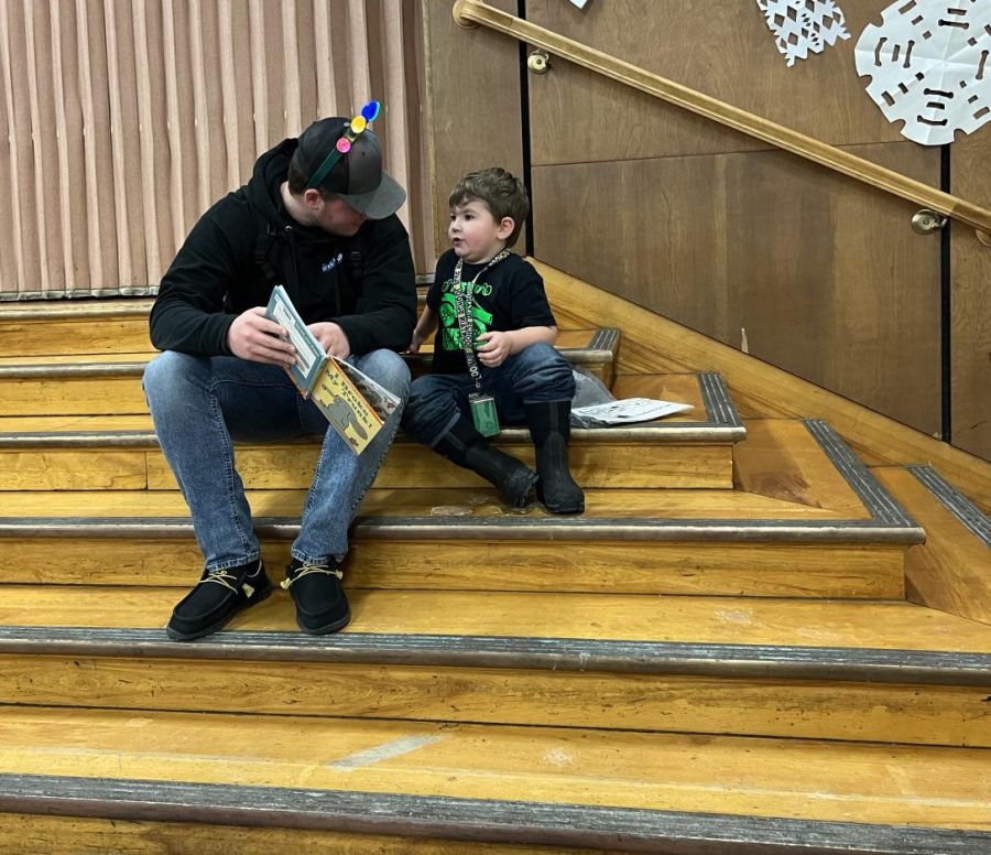 Sophomore Brody Kingsbury reads “I Broke My Trunk” by Mo Willems to pre-schooler Henry Lackey on Wednesday December 14th, 2022. 