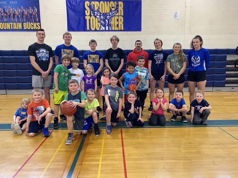 Kindergarten through second grade basketball players gather with high school volunteers at Saturday morning basketball on February 11th, 2023. 