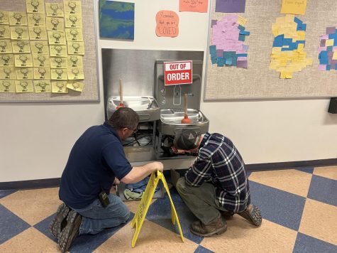 Custodial supervisor Clayton Hatch instructs sophomore Alex Fellows on fixing the water fountain in BMUs main hallway, on Friday March 24th.    