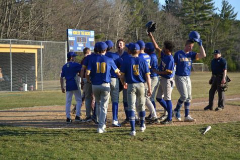 The Bucks surround home plate after Evan Denniss solo homerun in their season opener against the Richford Falcons on Thursday, April 13th.