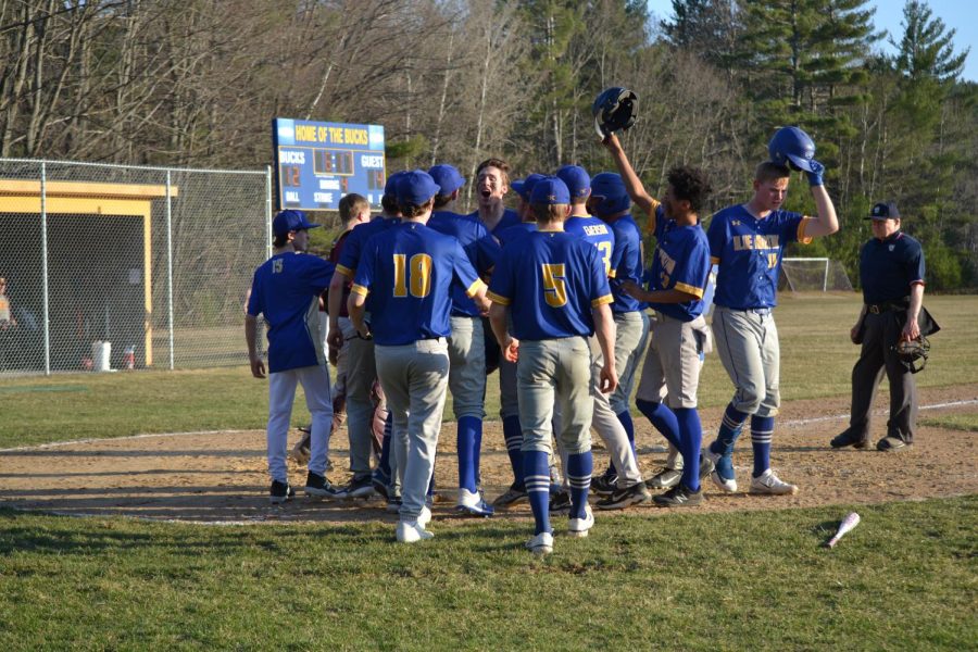 The+Bucks+surround+home+plate+after+Evan+Denniss+solo+homerun+in+their+season+opener+against+the+Richford+Falcons+on+Thursday%2C+April+13th.