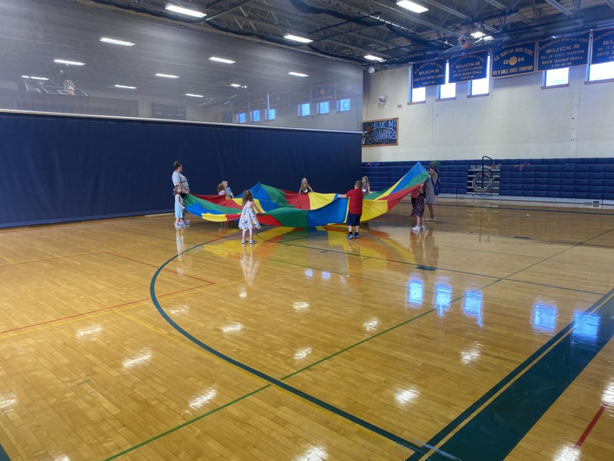 Mrs. Boutins kindergarten students have fun playing with the parachute in PE class on Friday, September 9, 2023.