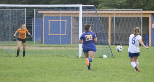 Thetford junior McKayla Stanley passes by BMU junior Madalyn Houghton and rips a shot on net.