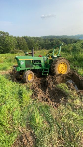 Local farmer Jacob Emersons John Deere 4020 is stuck while trying to hay.  The wet summer has made it difficult for Emerson to work the fields.