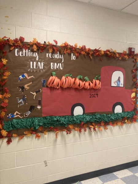 A display of leaves, pumpkins, and student images embellishes the senior bulletin board for the fall.