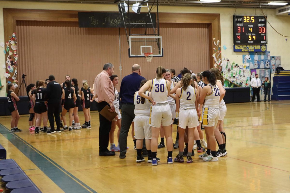 The Bucks huddle up around Coach Farquharson and talk over the game plan in a girls varsity contest on January 11th, 2024.   