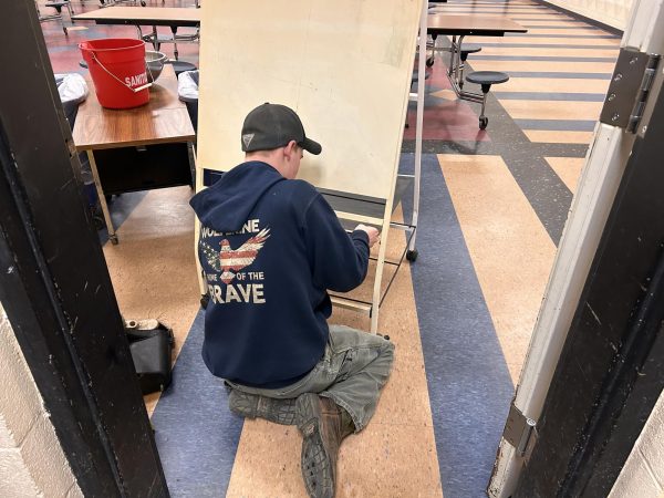 BMU student Alex Fellows helps custodians by dissembling a whiteboard on February 7th, 2024.  This is part of a work-study position in the school. 
