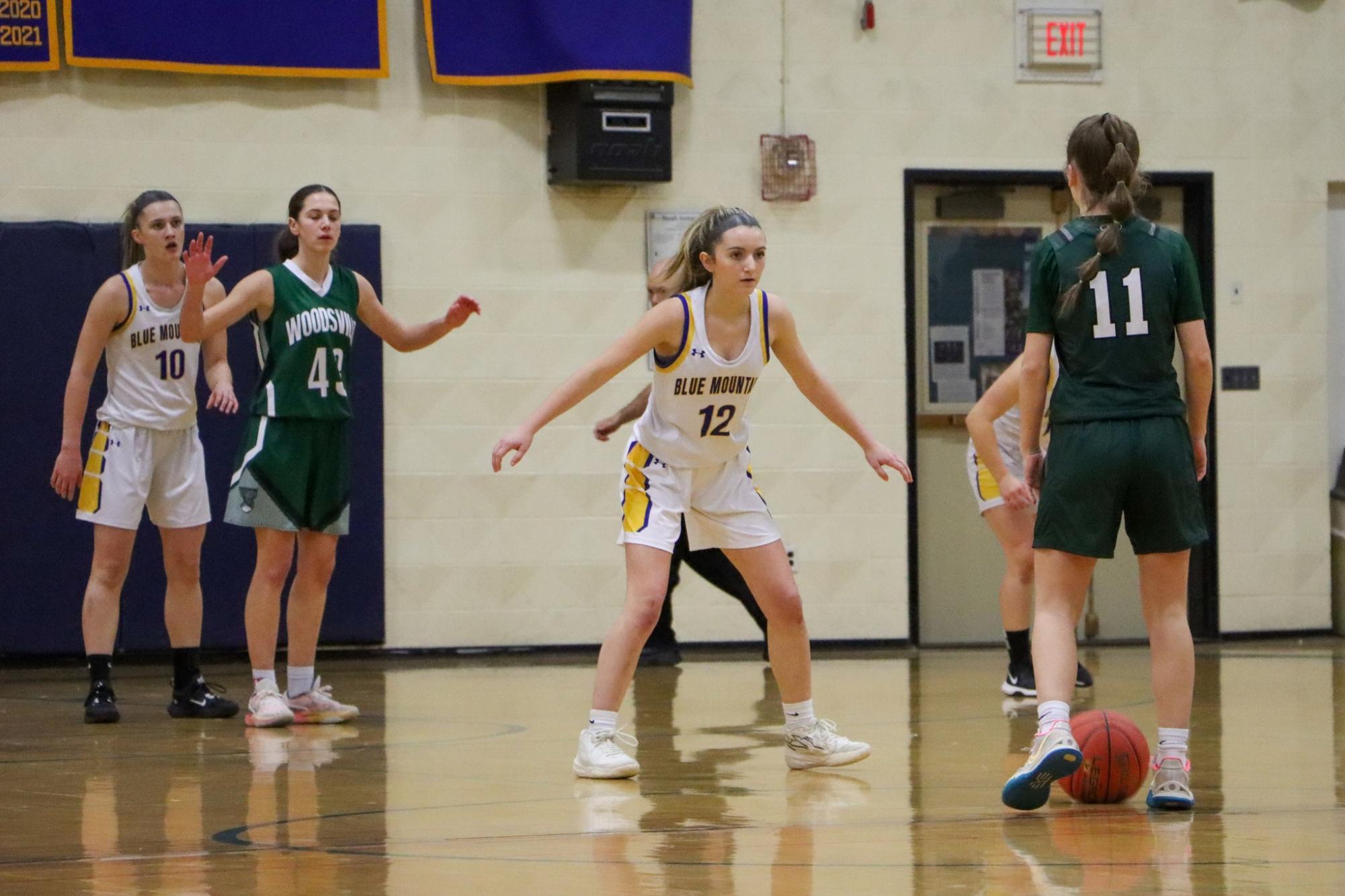 BMU freshman Addison Murray lines up to defend Woodsville sophomore Makayla Walker. Walker was held to only 4 points on the night opposed to her usual 12 ppg. 
