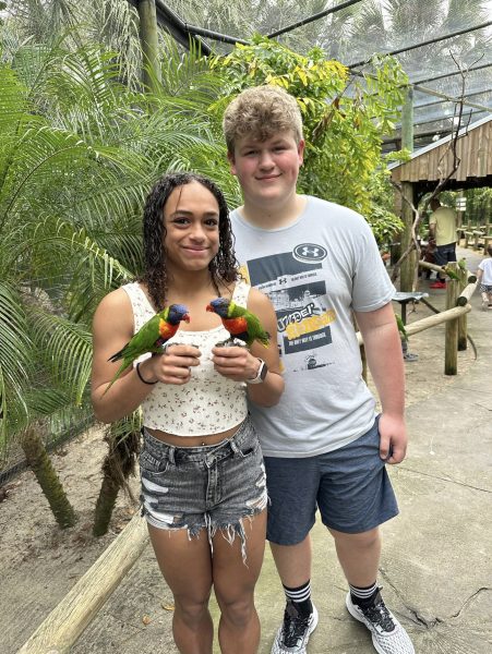 Local student Maya Christy is seen holding two Lorikeet birds at the Brevard Zoon in Melborne Florida February 11, 2024. The Brevard Zoo has a wide range of activities for visitors of all ages.