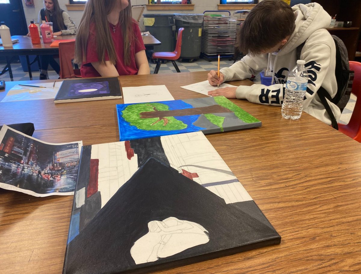 On Tuesday, February 6, 2024, Blue Mountain art student Gavin Longmoore (right) works on his painting for the Congressional Art competition. Five students will be chosen to submit and participate in the walk-through of all submitted art pieces in Montpelier on May 3rd.
