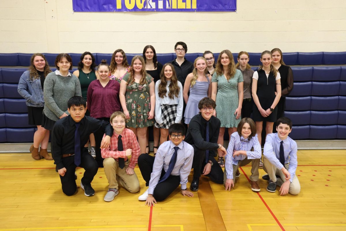 NHS, NJHS, and new inductees pose for a photo before the induction ceremony on March 14, 2024.