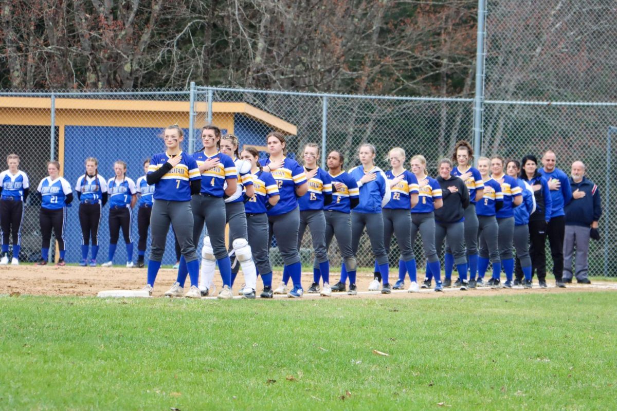 On Friday, April 19th in Wells River VT,  BMUs varsity softball team stands for the national anthem before playing the Craftsbury Chargers.
