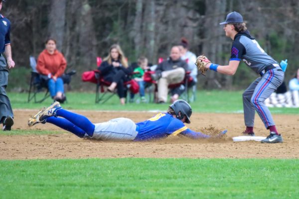 BMU senior Cameron Roy diving into second base to avoid the tag. 