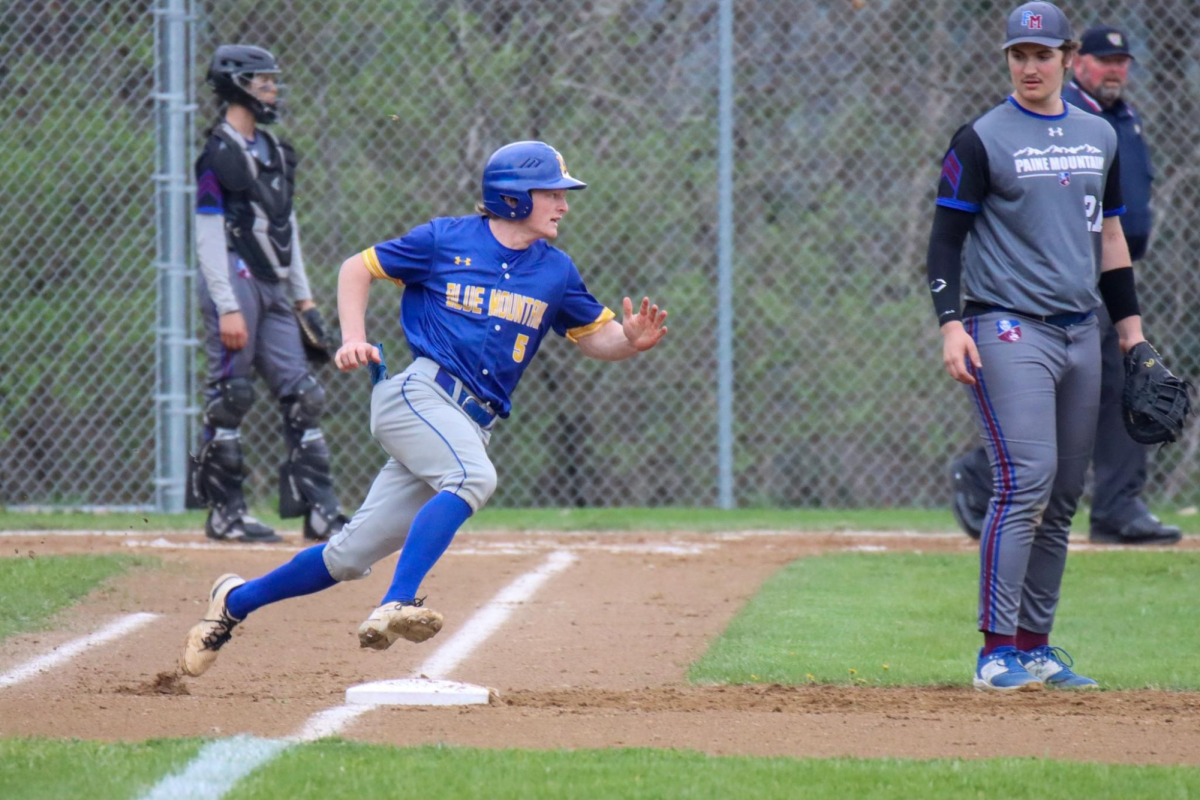Junior Kason Blood rounding first after getting a base hit at the Sabine field May 30th