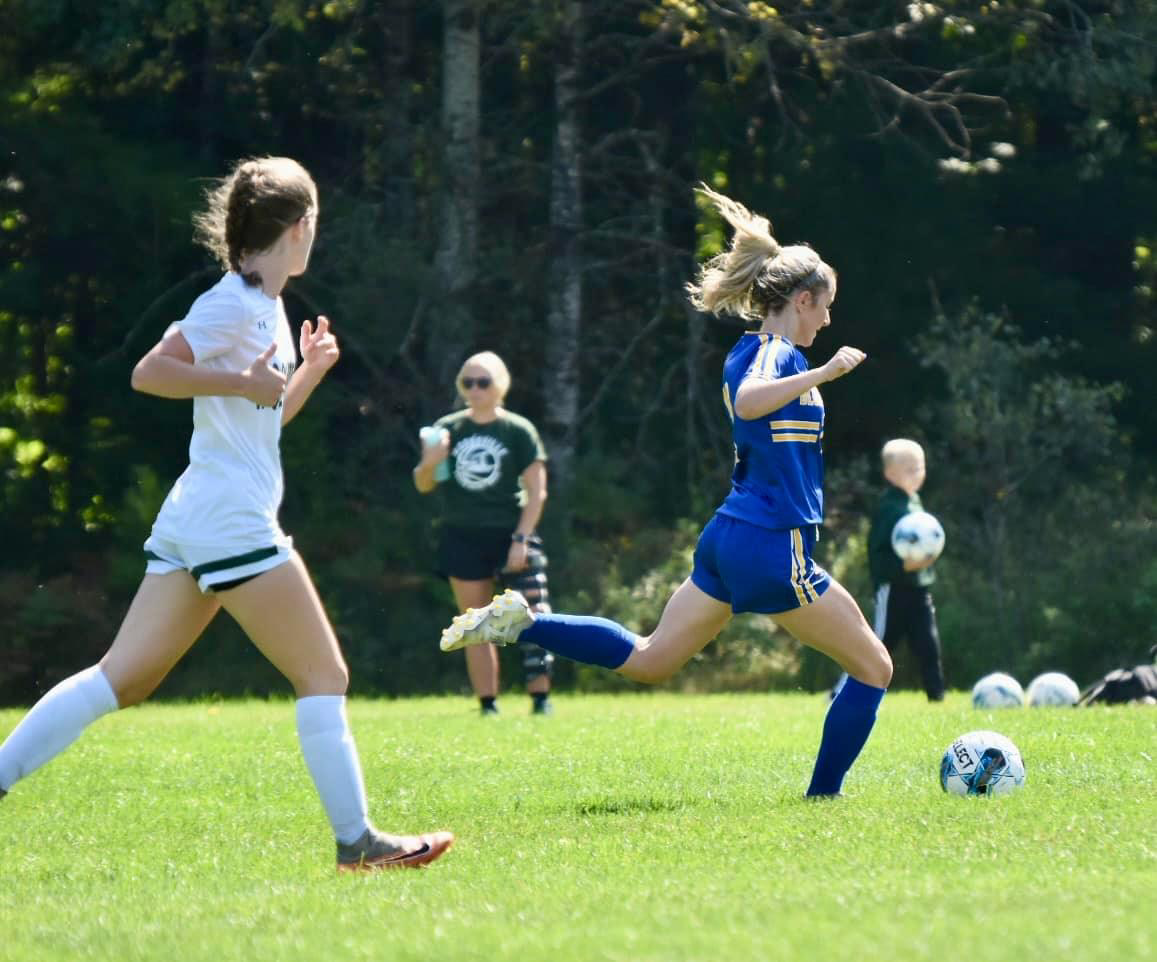 Woodsville junior Makayla Walker watches as BMU sophomore Addison Murray passes the ball up field on Saturday, September 14th at the Gerry Piper Athletic Field.