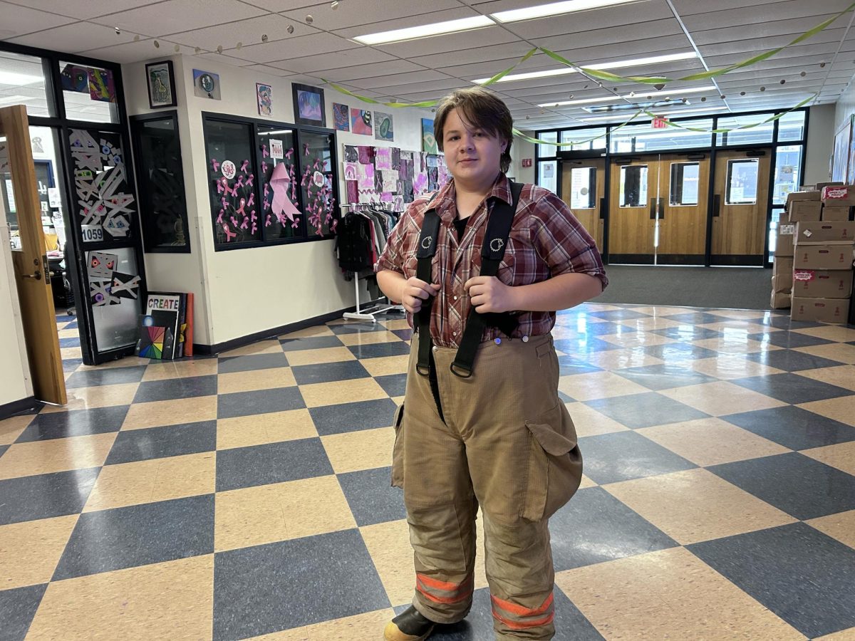 Sophomore Hunter Fisher poses for a photo in the Blue Mountain Union School main lobby, on October 31, 2024. Fisher shows his holiday spirit by dressing up as a firefighter.