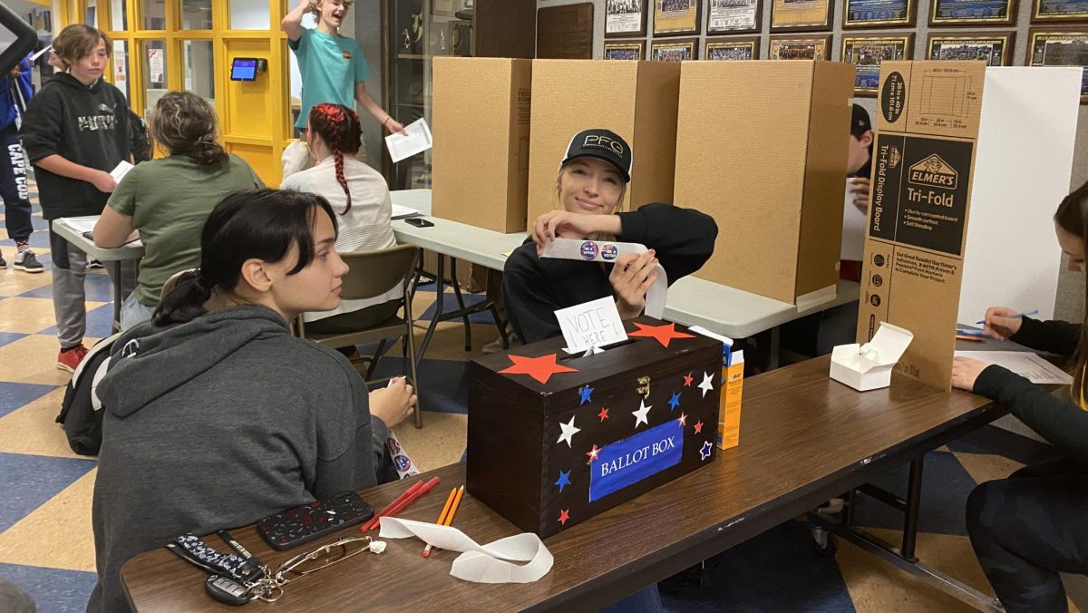 BMU’s U.S. Elections class held a mock election for 8-12 grade students. BMU sophomore, Tori Florentine, poses as she hands out “I voted” stickers. The mock election is held every four years to demonstrate what the voting process looks like on October 28, 2024, in Wells River, VT. 