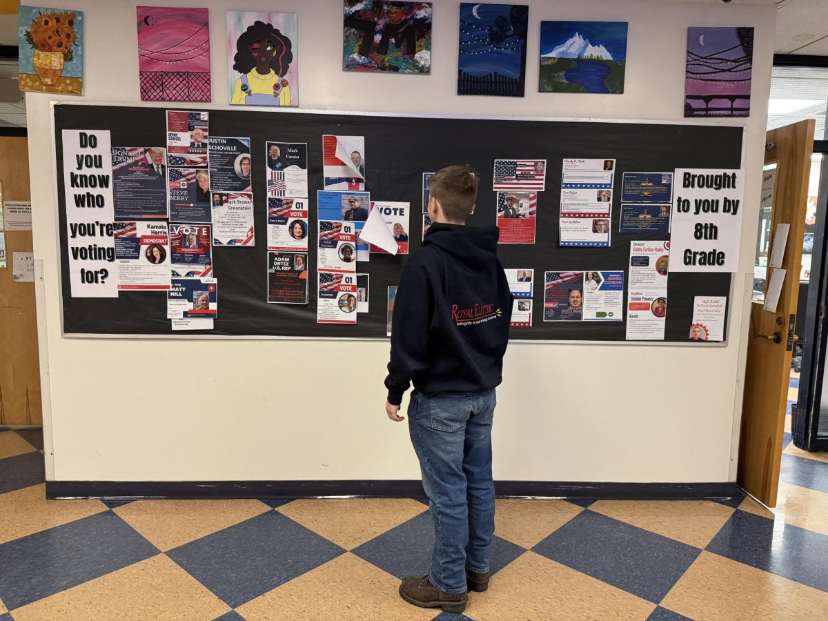 On Monday, October 28th, Kasey Ingerson looks at BMU 8th graders’ bulletin board in Wells River, VT. The board informs students about the candidates in the upcoming election.
