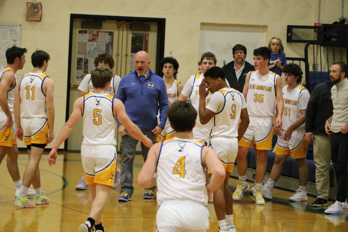 Chris Cook instructs the players on the floor to improve their defense in the Dr. Harry M. Rowe Gymnasium, Wells River, VT.