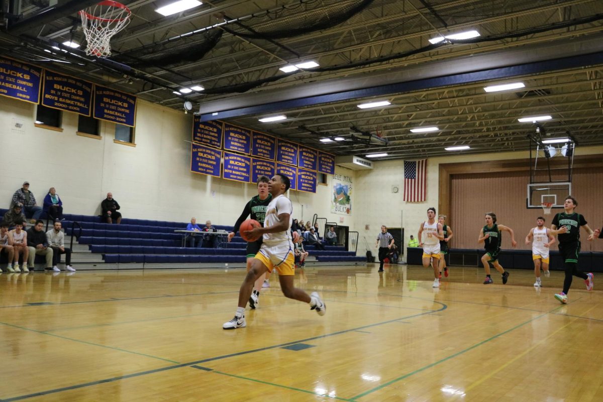 Jamal Saibou coming up for a lay up on a fast break in the Dr. Harry M. Rowe Gymnasium, Wells River, VT.
