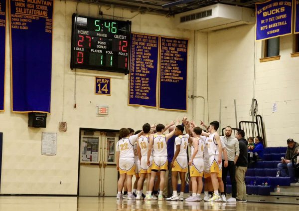 The Bucks break the huddle with a chant after a timeout in the second quarter in the Dr. Harry M. Rowe Gymnasium, Wells River, VT.