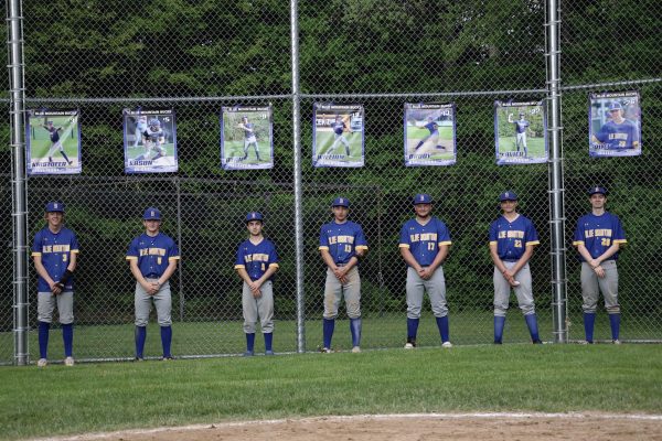 BMU Seniors line up under their banners. (L-R) Kris Fennimore, Kason Blood, Ryan Metzler, William Emerson, Brody Kingsbury, Xavier Mattoon, Riley Hatch. On Friday May 24th, 2025,on the Ron Brown Athletic Field.