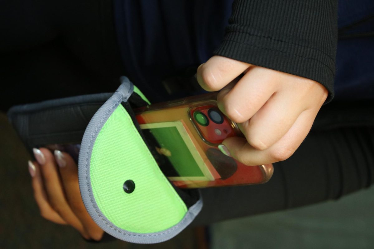 An unnamed BMU student placing their cell phone in their Yondr pouch on Thursday September 11, 2025.  The pouches are a new tool used at Blue Mountain to help students comply with the schools no cell phone policy.