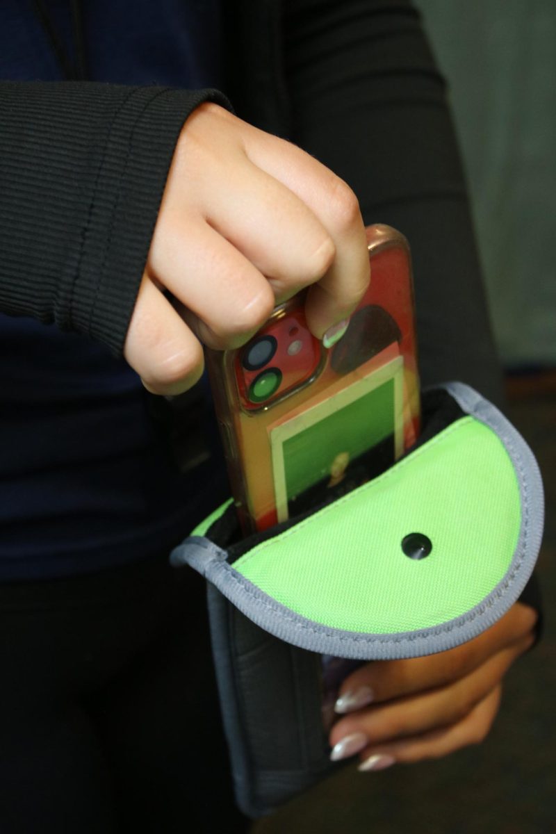 An unnamed BMU student placing their cell phone in their Yondr pouch on Thursday September 11, 2025.  The pouches are a new tool used at Blue Mountain to help students comply with the schools no cell phone policy.