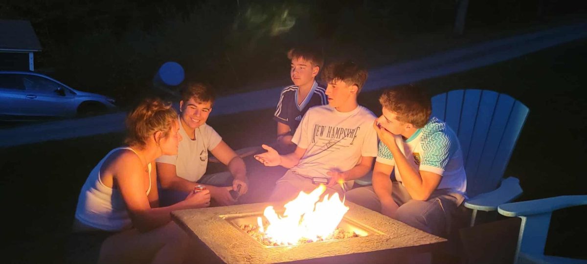 Blue Mountain students and their Spanish counterparts, interact around a fire on September 28th, 2025. The students just arrived in Vermont and are starting to get to know each other.
