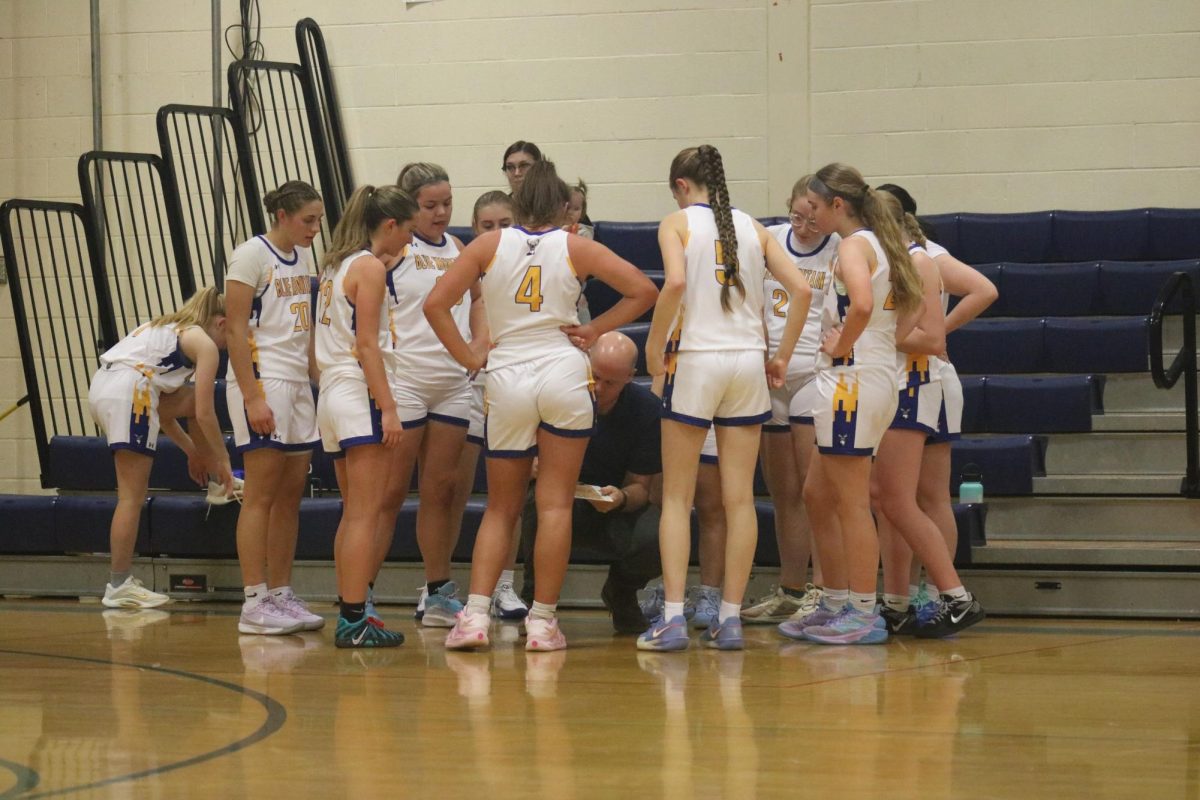 Varsity Bucks listening to their coach on a time out at the JV and Varsity scrimmage on December 9th 2025.
