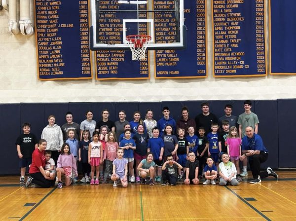 Blue Mountain K-2 smile with their high school coaches in the Dr. Harry M. Rowe Gymnasium on February 14, 2026. Students learn fundamentals and play games on the last Saturday morning basketball practice of the year.  
